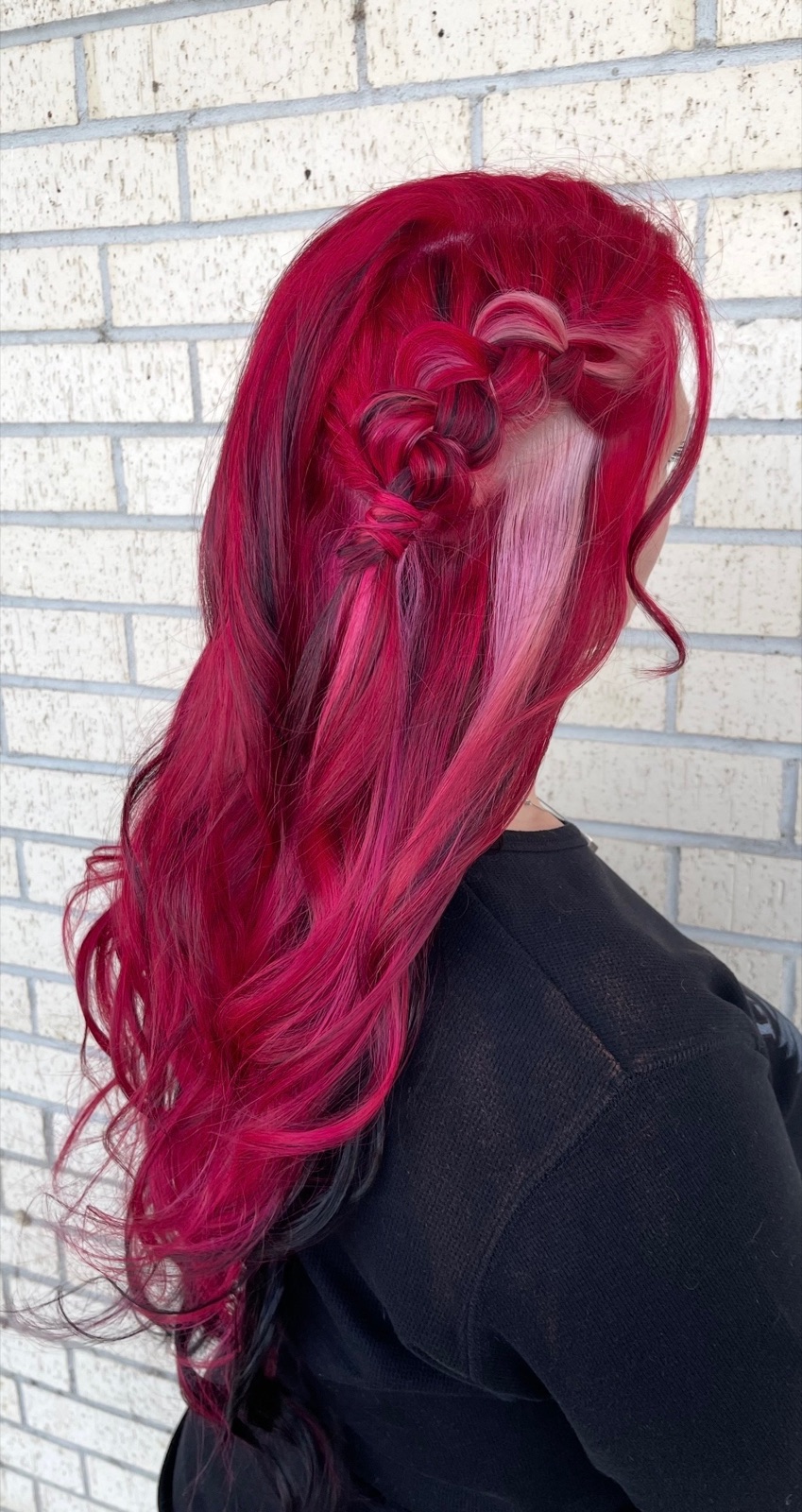 Red and pink vivid color styled with a decorative braid by Dusty Ozanich