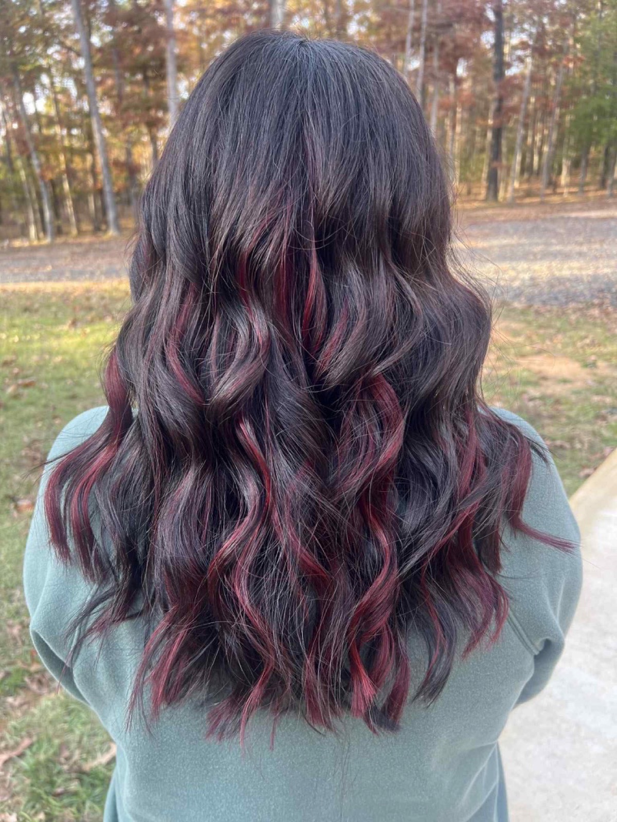 Dark hair with vivid red highlights by Jade Ferguson