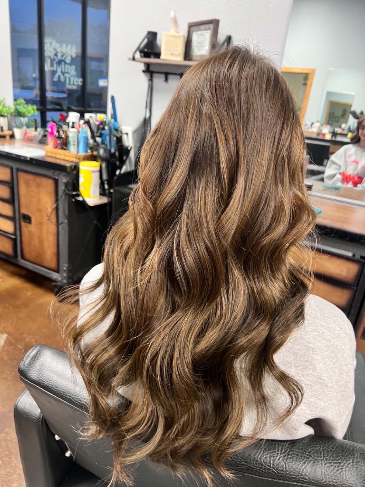 Long warm brunette color styled in waves by Jade Ferguson