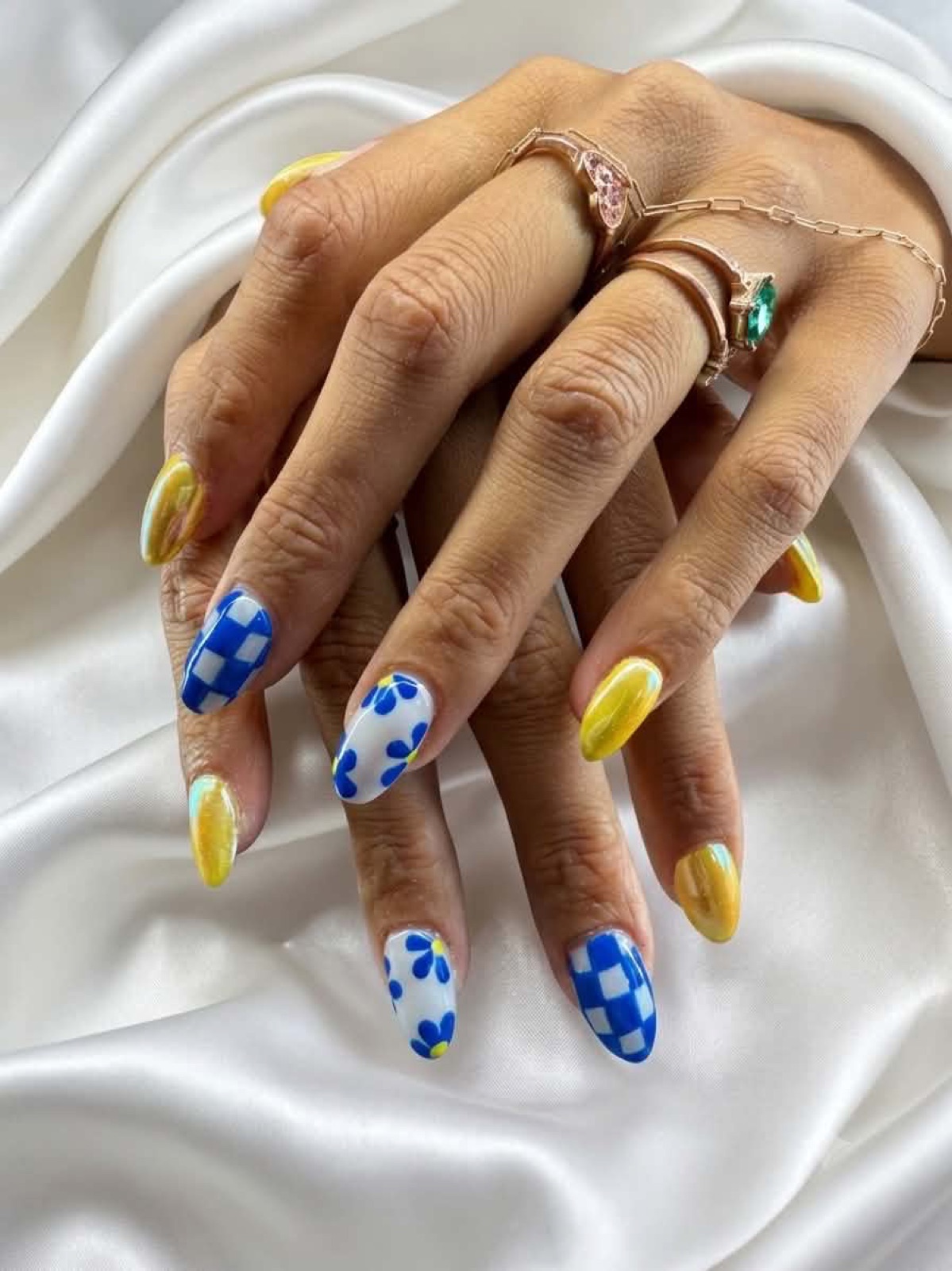 Blue, yellow, and white patterned nail art by Kayla Page