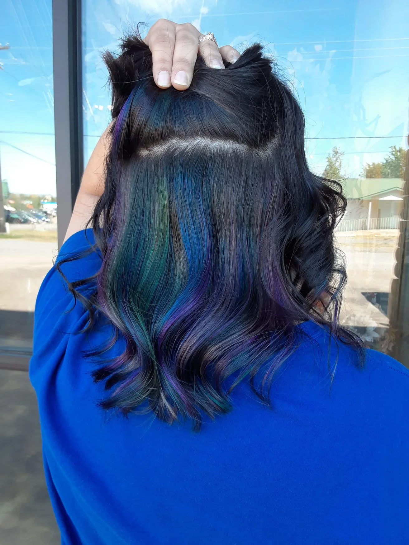 Hidden blue, green, and purple vivid color beneath dark hair by Kristen Wilhite